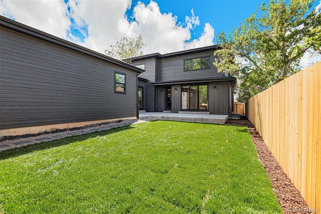 rear view of property featuring a yard