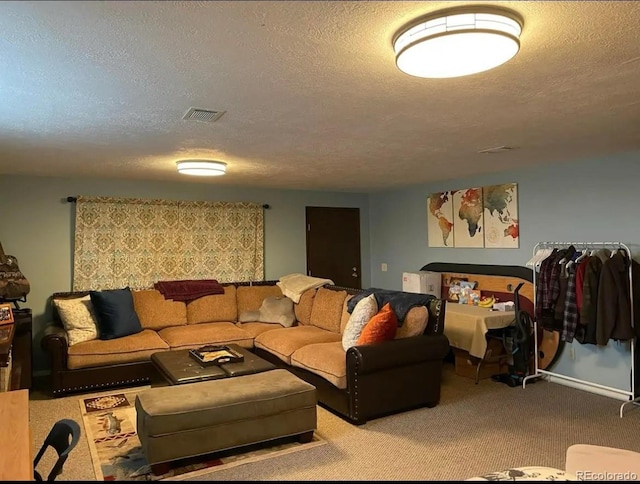 carpeted living area featuring a textured ceiling and visible vents