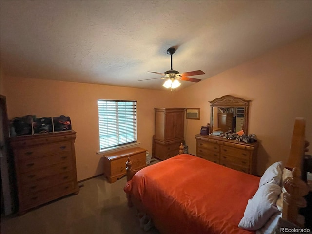 bedroom featuring carpet, vaulted ceiling, a textured ceiling, and ceiling fan