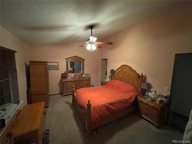 bedroom with lofted ceiling, ceiling fan, and carpet flooring