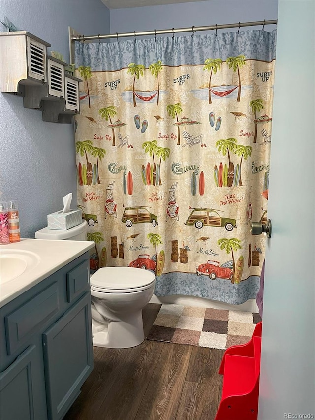 bathroom with vanity, hardwood / wood-style floors, and toilet