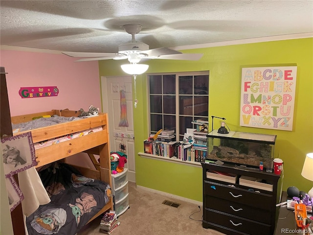 bedroom featuring baseboards, visible vents, ornamental molding, carpet, and a textured ceiling