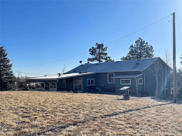 rear view of property with a sunroom