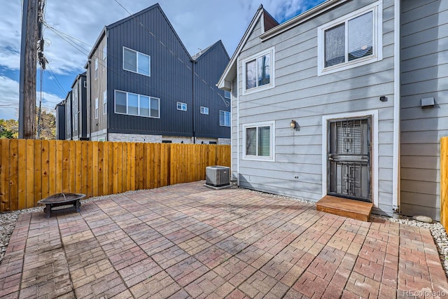 view of patio / terrace featuring central AC and a fire pit