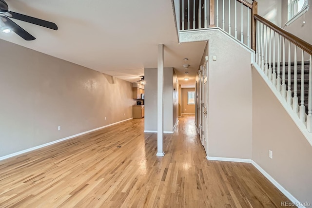 interior space with ceiling fan, a wealth of natural light, and light hardwood / wood-style flooring