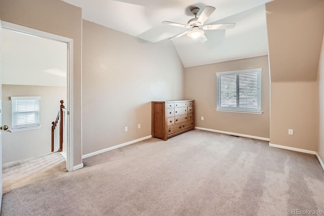 additional living space featuring light colored carpet, ceiling fan, and lofted ceiling