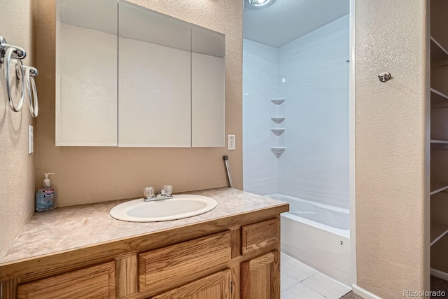 bathroom with tile patterned floors and vanity