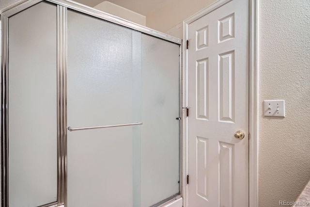 bathroom with a shower with shower door