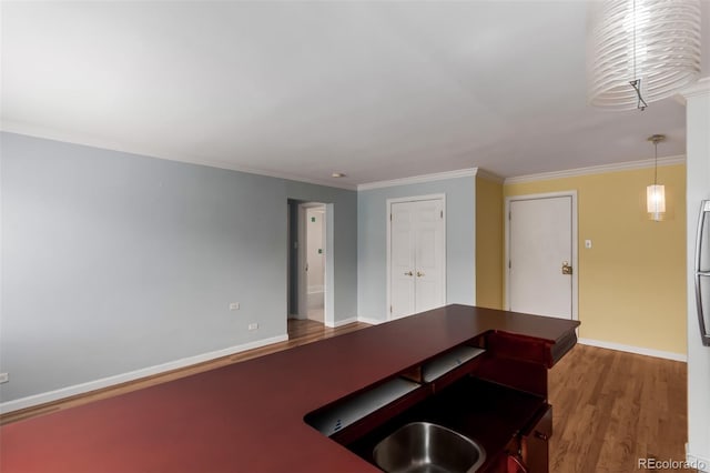 1450 Albion St Unit 204, Denver, CO 80220 - kitchen featuring wood finished floors, crown molding, freestanding refrigerator, and dark countertops