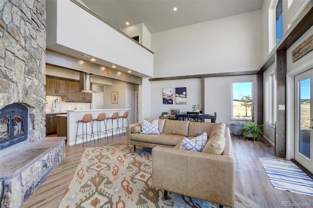 10617 County Rd 1, Florissant, CO 80816 - living room with a high ceiling, a fireplace, light wood-style floors, and recessed lighting