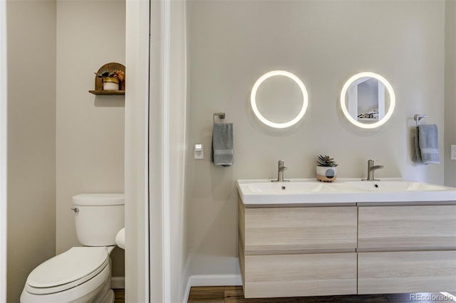 10617 County Rd 1, Florissant, CO 80816 - bathroom featuring toilet, double vanity, and baseboards