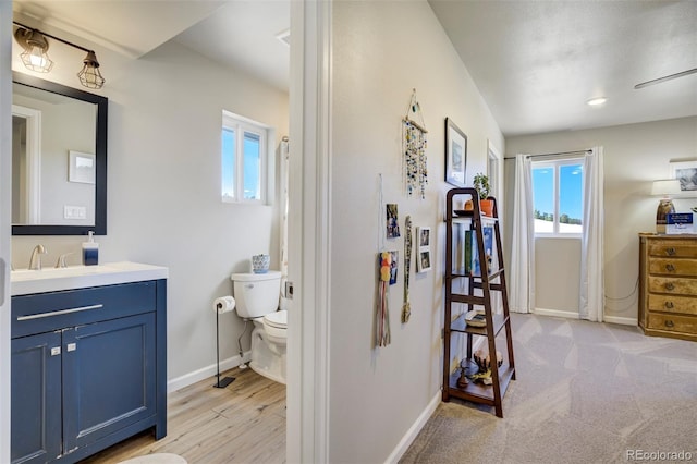 10617 County Rd 1, Florissant, CO 80816 - bathroom featuring healthy amount of natural light, toilet, baseboards, and vanity
