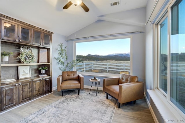 10617 County Rd 1, Florissant, CO 80816 - living area featuring ceiling fan, vaulted ceiling, light wood-type flooring, a mountain view, and baseboards