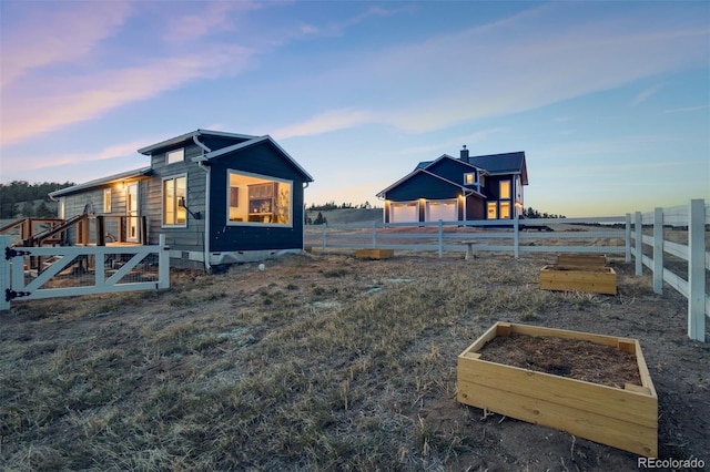 10617 County Rd 1, Florissant, CO 80816 - yard at dusk with fence and a vegetable garden