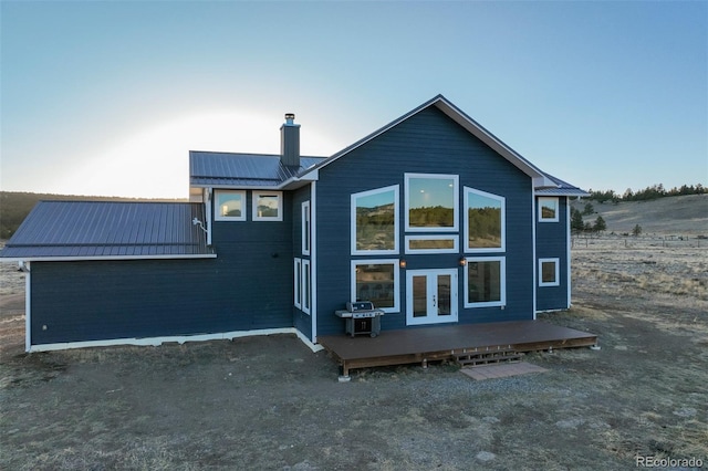 10617 County Rd 1, Florissant, CO 80816 - rear view of property with french doors, a chimney, metal roof, and a deck