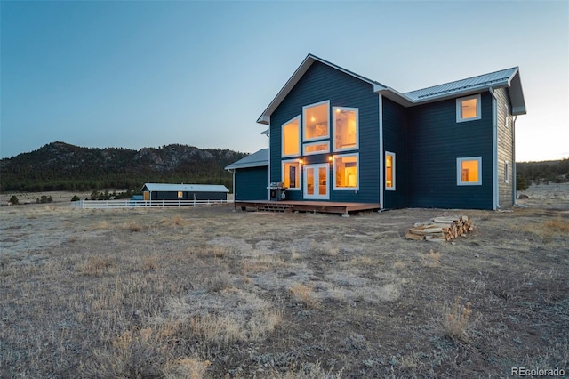 10617 County Rd 1, Florissant, CO 80816 - rear view of house featuring metal roof, french doors, and a wooden deck