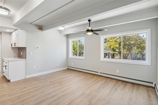 interior space with ceiling fan, baseboard heating, and light hardwood / wood-style flooring