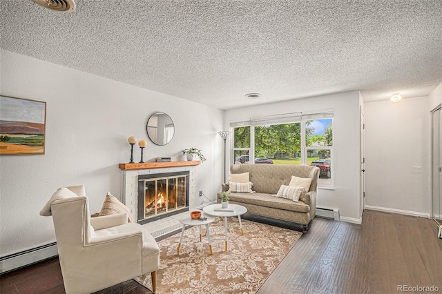 64 Nome Way Unit A, Aurora, CO 80012 - living area featuring baseboard heating, a fireplace, hardwood / wood-style floors, and a textured ceiling