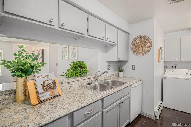 64 Nome Way Unit A, Aurora, CO 80012 - kitchen featuring washer / clothes dryer, dishwasher, dark wood-style flooring, light countertops, and a baseboard radiator