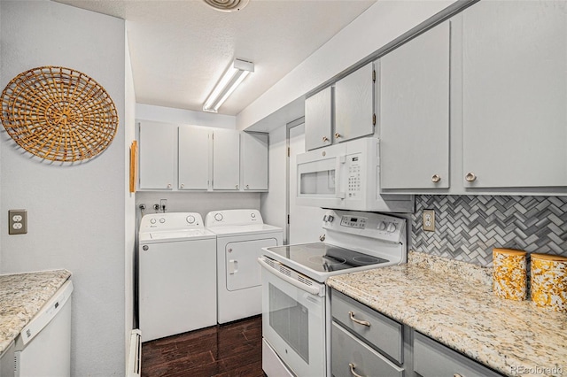 64 Nome Way Unit A, Aurora, CO 80012 - kitchen featuring white appliances, washer and dryer, gray cabinets, light countertops, and decorative backsplash