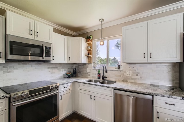 9146 W 89th Ct, Broomfield, CO 80021 - kitchen featuring stainless steel appliances, a sink, decorative backsplash, pendant lighting, and white cabinetry