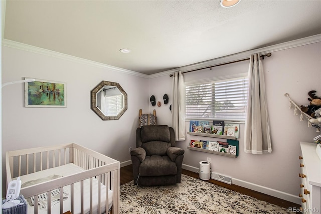 9146 W 89th Ct, Broomfield, CO 80021 - bedroom with a crib, baseboards, crown molding, wood finished floors, and recessed lighting