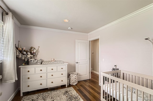 9146 W 89th Ct, Broomfield, CO 80021 - bedroom with dark wood finished floors, a nursery area, crown molding, baseboards, and recessed lighting