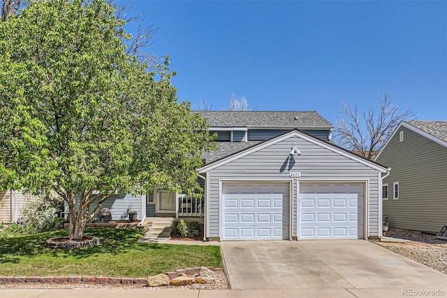 view of front of house featuring roof with shingles, an attached garage, concrete driveway, and a front lawn