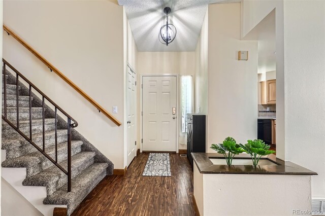 entryway with baseboards, dark wood finished floors, and stairway