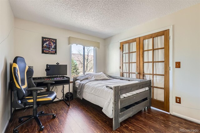 bedroom with dark wood-style flooring and a textured ceiling