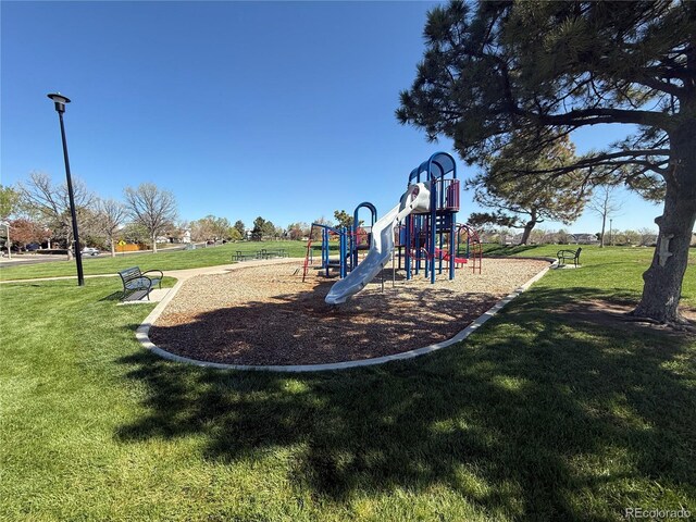 community jungle gym featuring a lawn