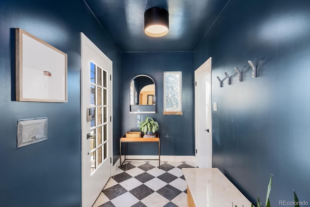 doorway featuring baseboards and tile patterned floors