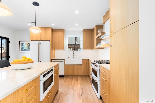 kitchen with white appliances, a healthy amount of sunlight, a sink, and open shelves