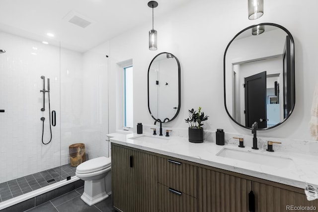 bathroom featuring tile patterned floors, a sink, toilet, and a shower stall