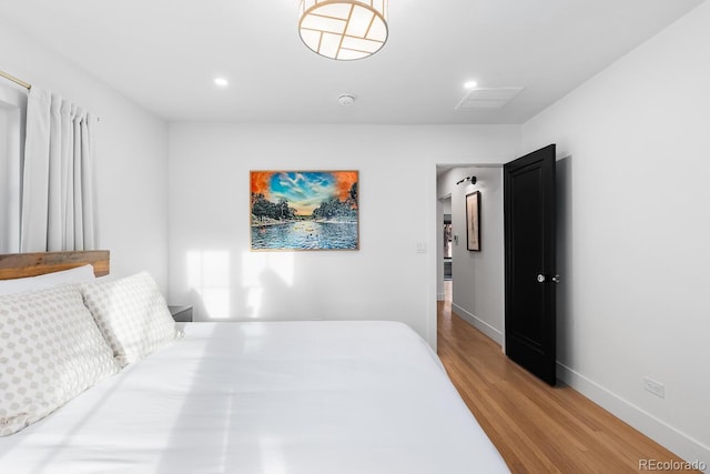 bedroom featuring light wood-style floors, recessed lighting, and baseboards