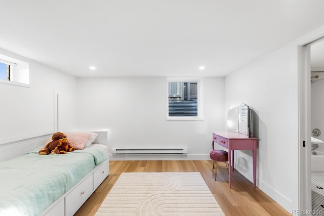 bedroom with baseboards, light wood-type flooring, a baseboard radiator, and recessed lighting