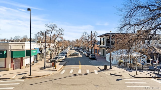 view of street with curbs, street lighting, and sidewalks