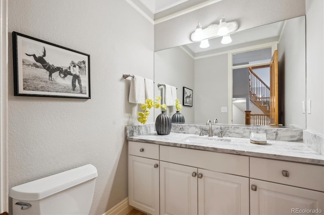 4059 Nevis St, Boulder, CO 80301 - bathroom featuring toilet, vanity, crown molding, and a textured wall