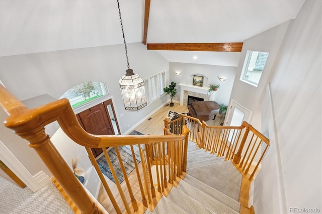 4059 Nevis St, Boulder, CO 80301 - stairs with beam ceiling, high vaulted ceiling, baseboards, a tiled fireplace, and recessed lighting