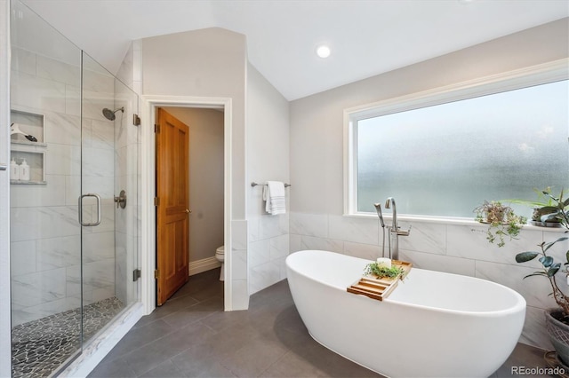 4059 Nevis St, Boulder, CO 80301 - full bath with a stall shower, a freestanding bath, vaulted ceiling, toilet, and tile walls