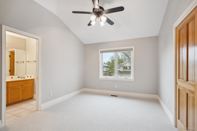 4059 Nevis St, Boulder, CO 80301 - unfurnished bedroom with light carpet, vaulted ceiling, ensuite bathroom, baseboards, and a ceiling fan
