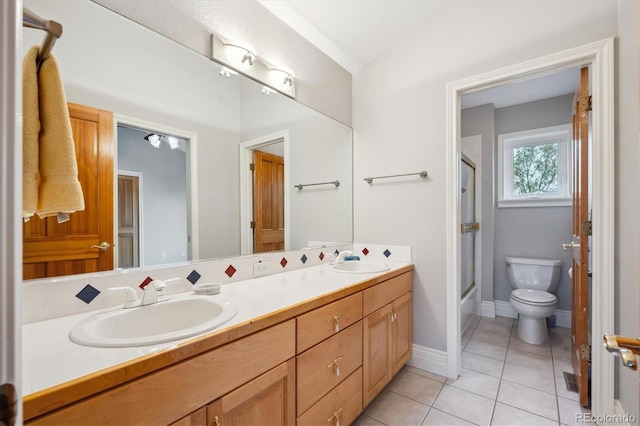 4059 Nevis St, Boulder, CO 80301 - full bath with double vanity, toilet, tile patterned floors, baseboards, and enclosed tub / shower combo