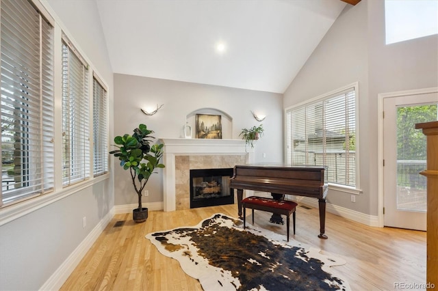 4059 Nevis St, Boulder, CO 80301 - sitting room with a tile fireplace, wood finished floors, baseboards, and high vaulted ceiling
