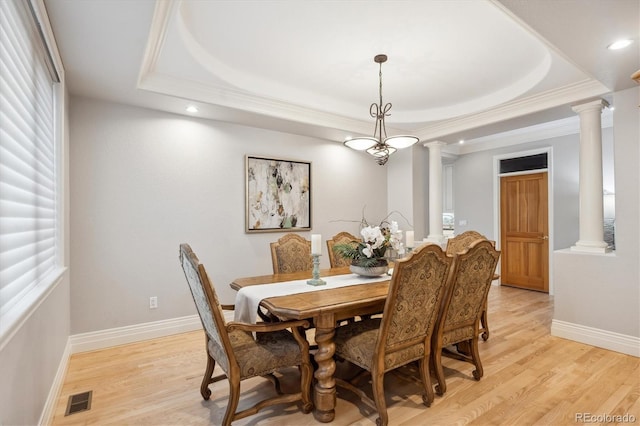 4059 Nevis St, Boulder, CO 80301 - dining area featuring decorative columns, a raised ceiling, light wood-style floors, recessed lighting, and crown molding