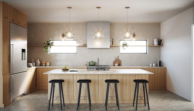 kitchen with pendant lighting, high quality fridge, a kitchen island, and a kitchen breakfast bar