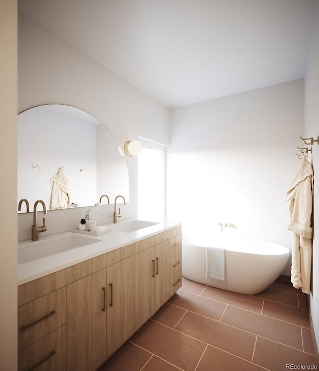 bathroom with tile patterned flooring, a tub to relax in, and vanity