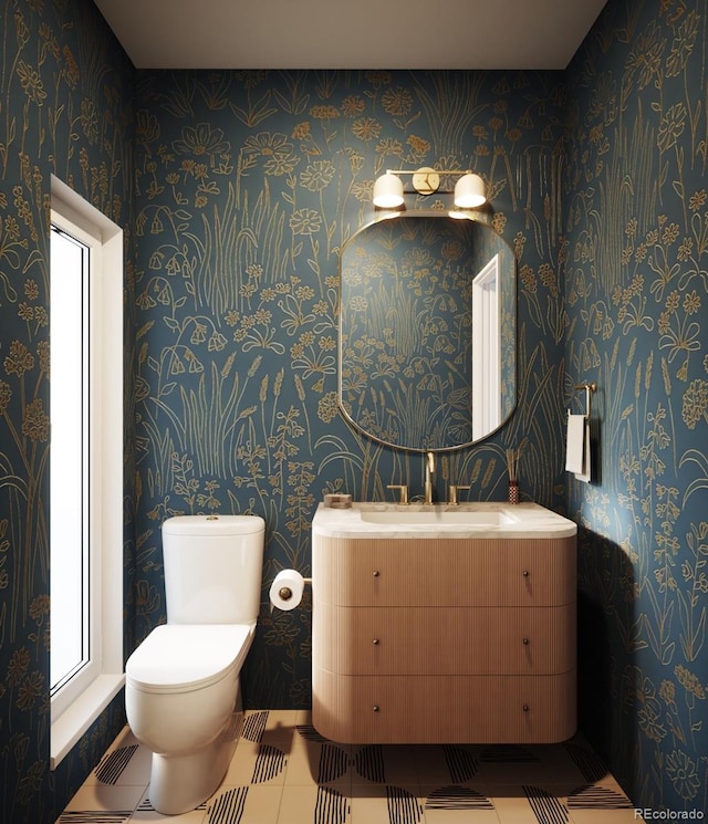 bathroom featuring tile patterned flooring, vanity, and toilet