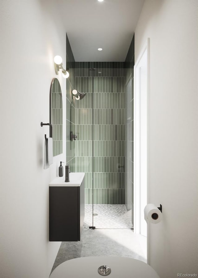 bathroom with vanity and tiled shower