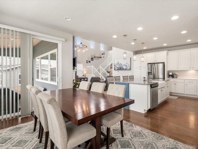 dining space featuring stairs, plenty of natural light, wood finished floors, and recessed lighting