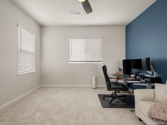 office with visible vents, baseboards, a ceiling fan, and light colored carpet